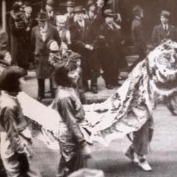 Girls Carry the Lion Through Chinatown [photograph]